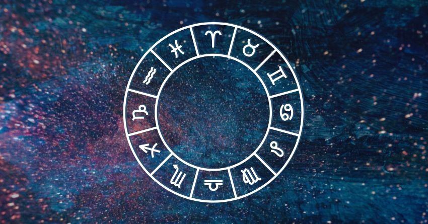 Blue zodiac wheel surrounded by colorful cosmic clouds and glowing celestial energy