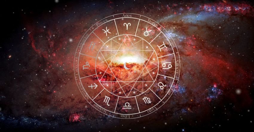 Red zodiac wheel surrounded by fiery orange cosmic energy on a dark background