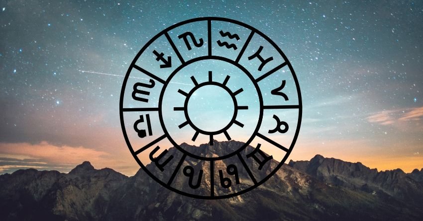 Zodiac wheel in the night sky above a mountain landscape