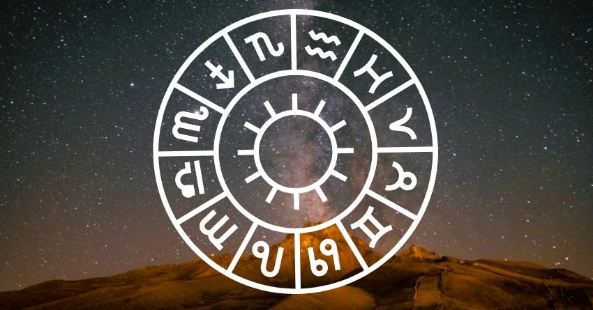 Zodiac wheel representing the twelve zodiac signs under a starry night sky