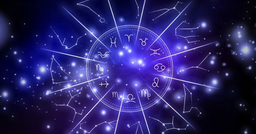 Zodiac wheel with glowing zodiac signs and celestial stars in a dark blue cosmic background