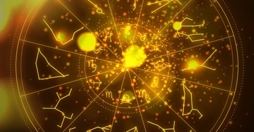 Glowing golden zodiac symbols surrounded by bright cosmic energy and sparkling light