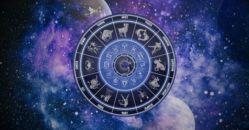 Glowing blue zodiac wheel surrounded by purple and blue cosmic clouds on a dark background