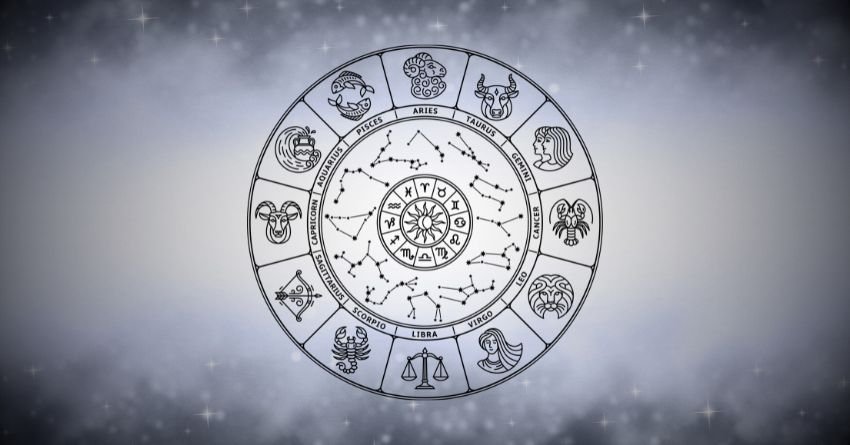 Silver zodiac wheel glowing through soft gray and white mist